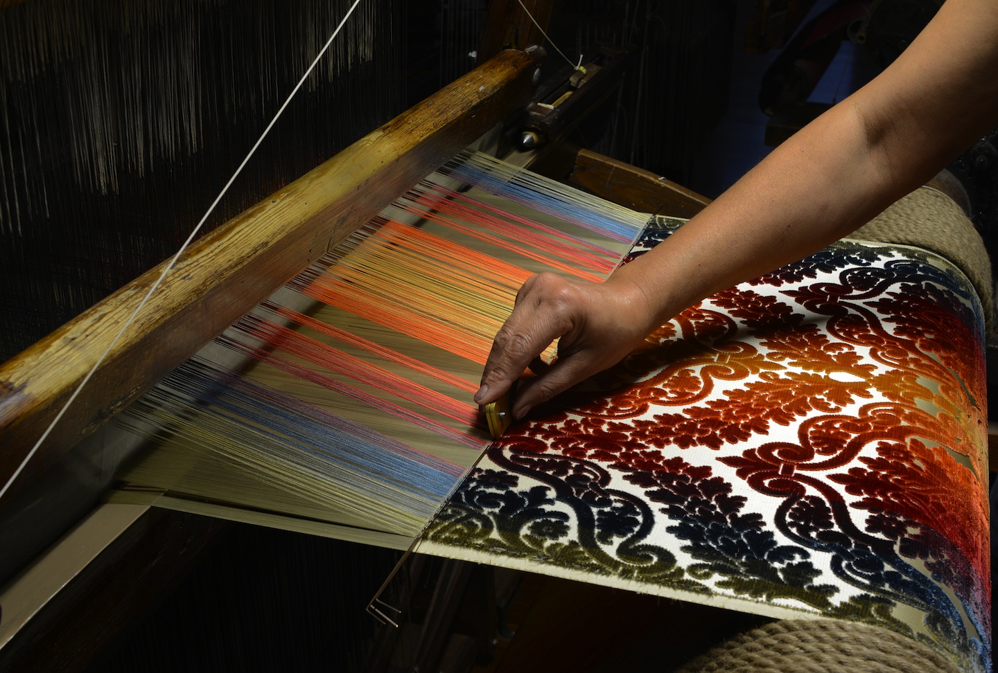 rich woven Florentine textile on a wooden artisan