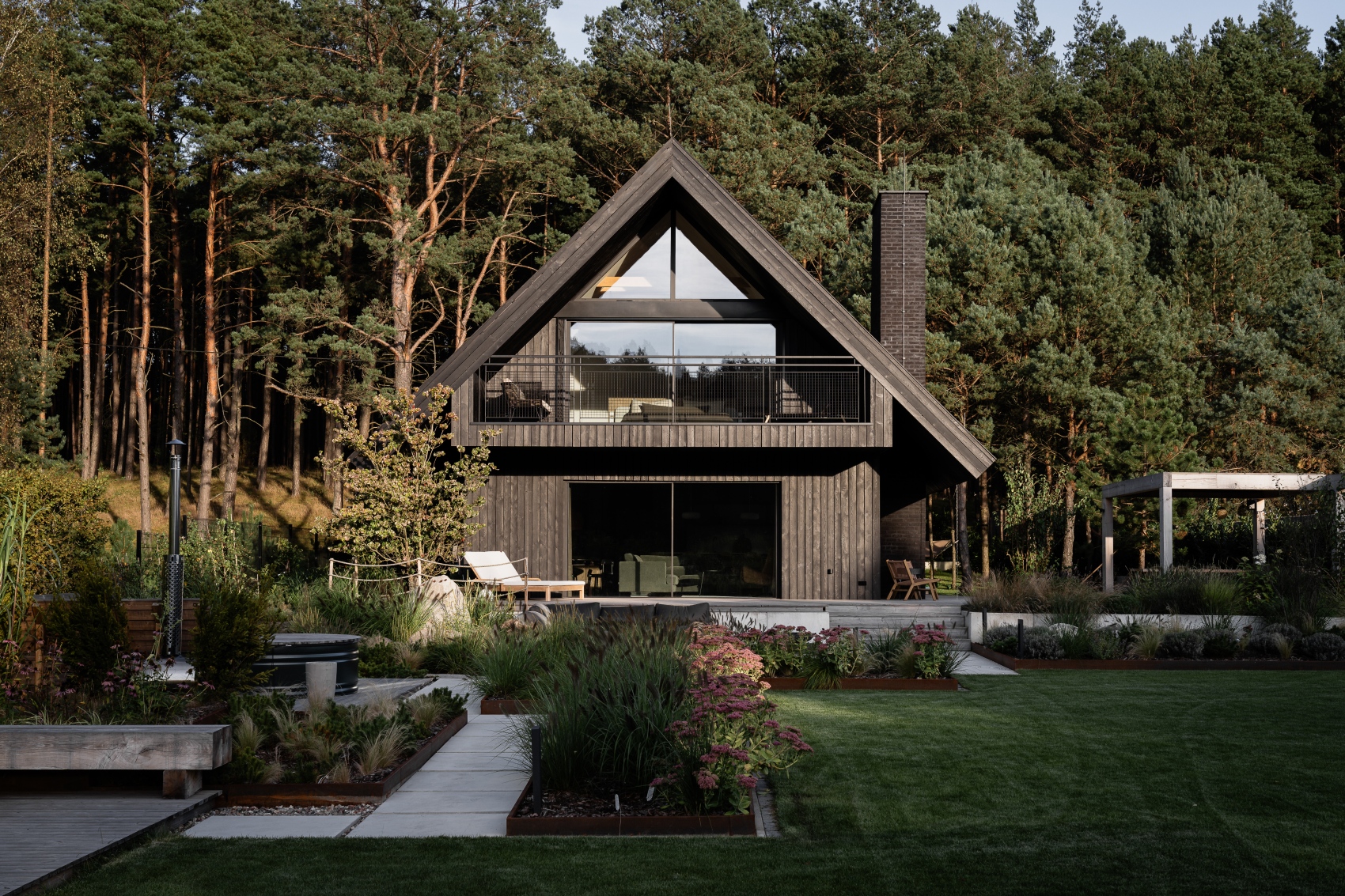 minimalist timber facade blending into a dense forest