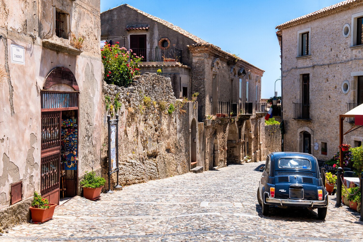 ancient stone houses narrow village street 2026