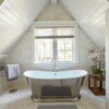 freestanding bathtub microcement floor sloping attic skylight