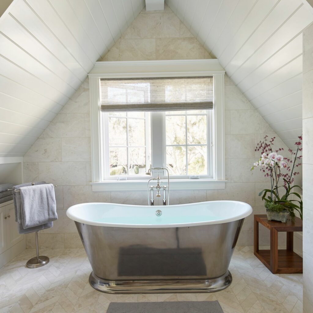 freestanding bathtub microcement floor sloping attic skylight