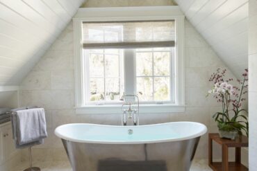freestanding bathtub microcement floor sloping attic skylight