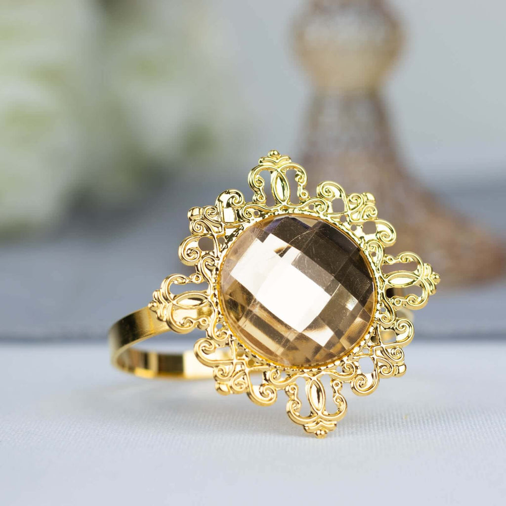 gold plated napkin ring studded with gemstones