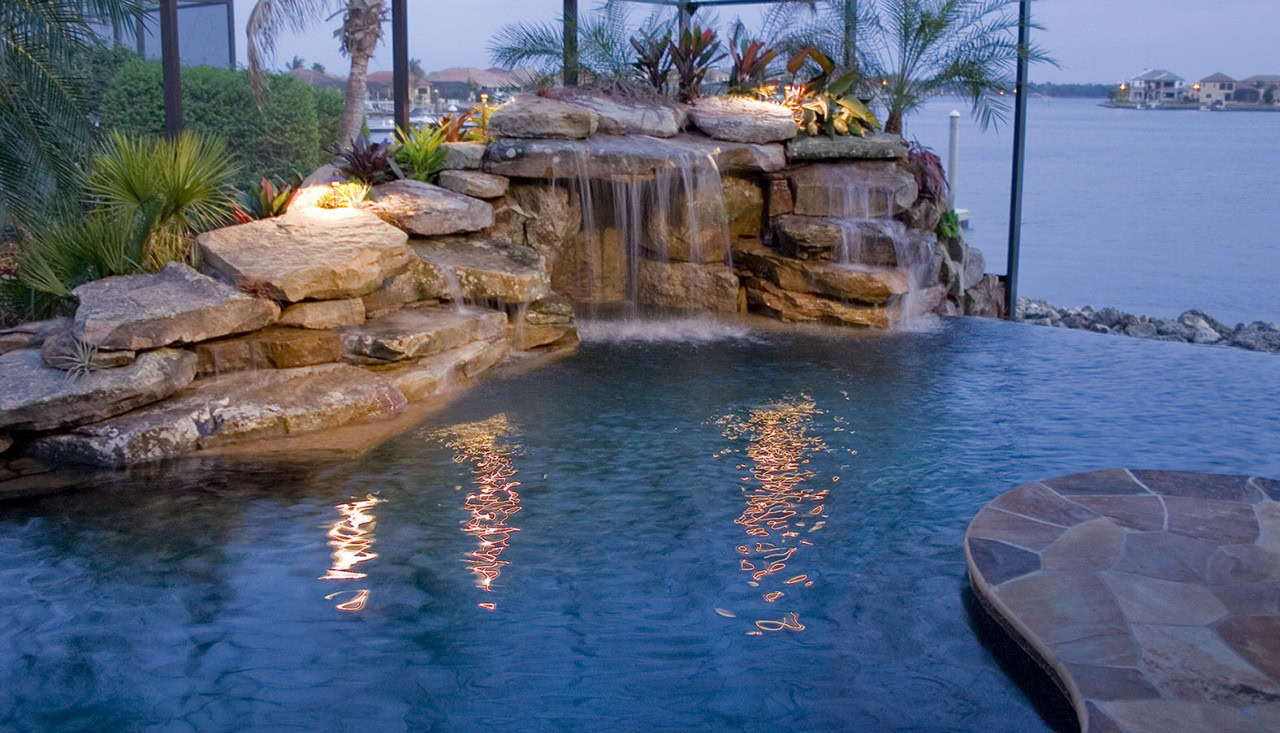 infinity edge swimming pool with limestone terrace and