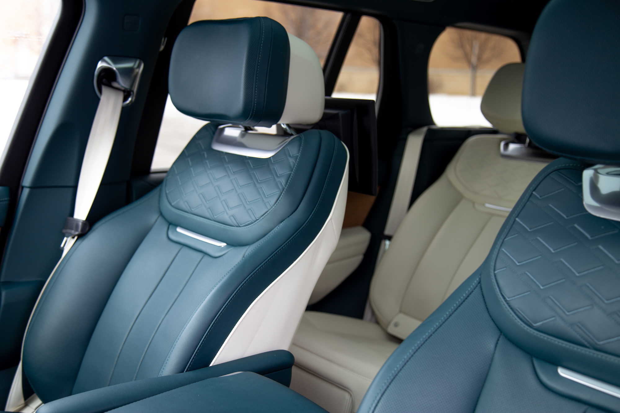 Quilted cream leather upholstery with electric blue stitching