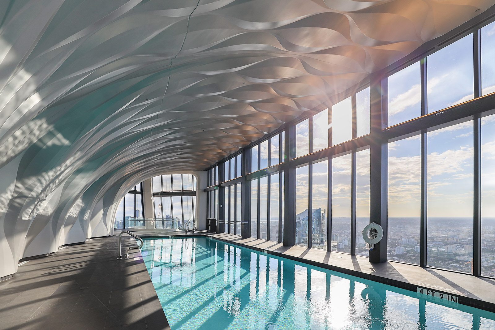 rooftop infinity pool with glass edge overlooking Miami
