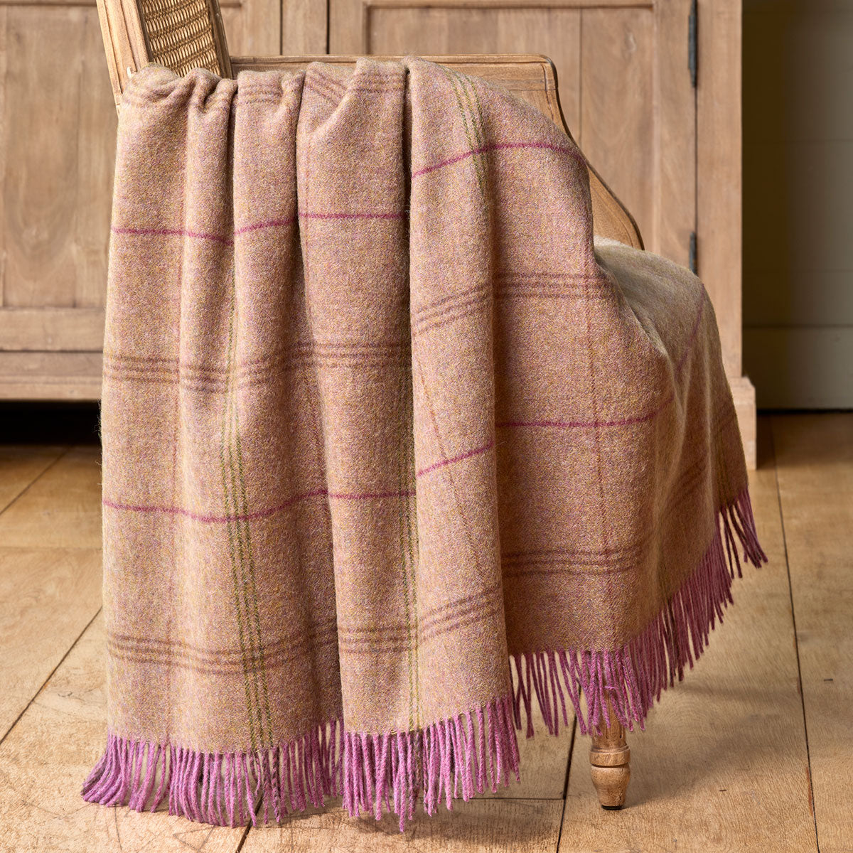tartan wool throw blanket on velvet armchair