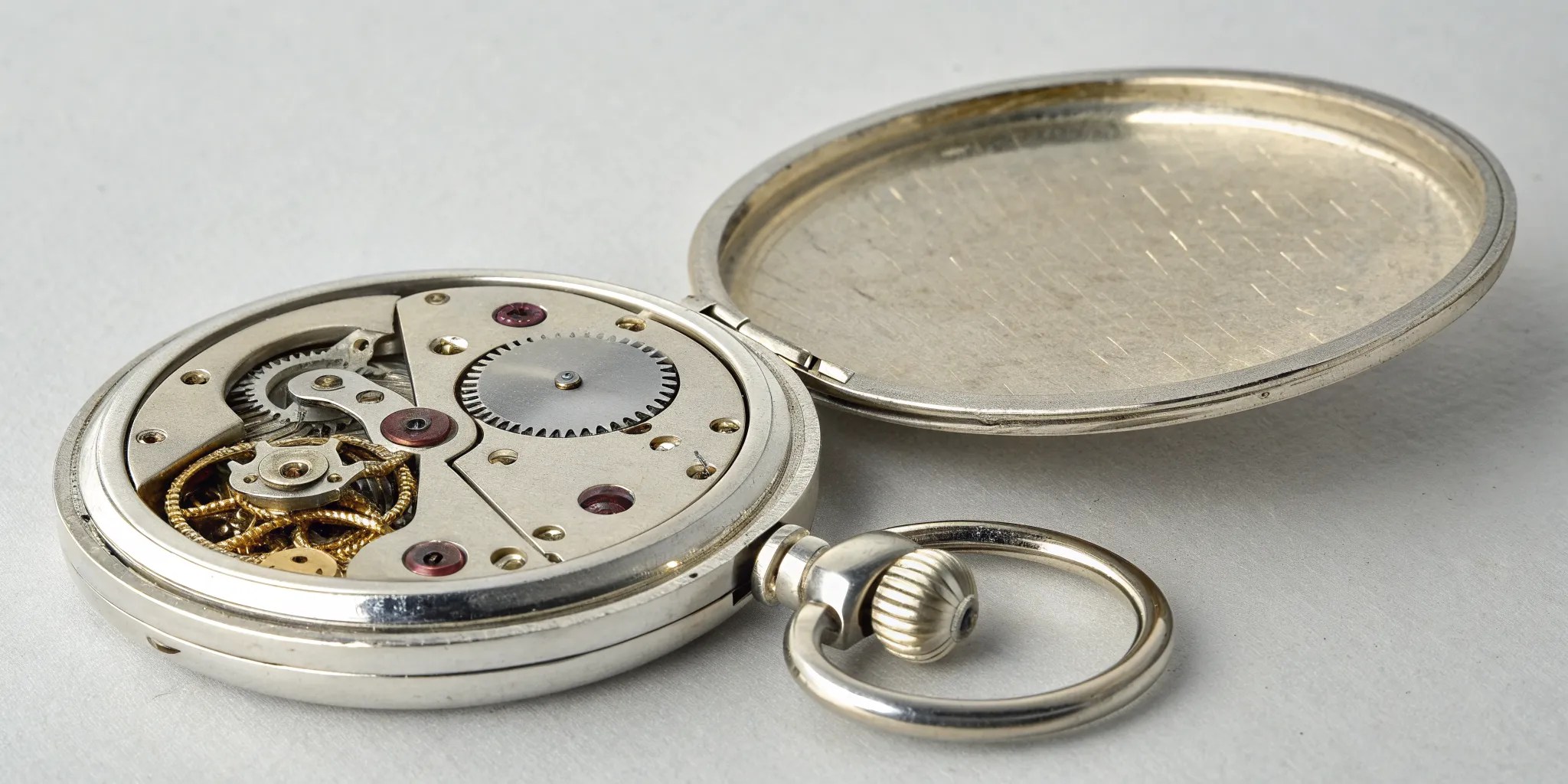 expert magnifying glass on engraved serial number of vintage gold watch