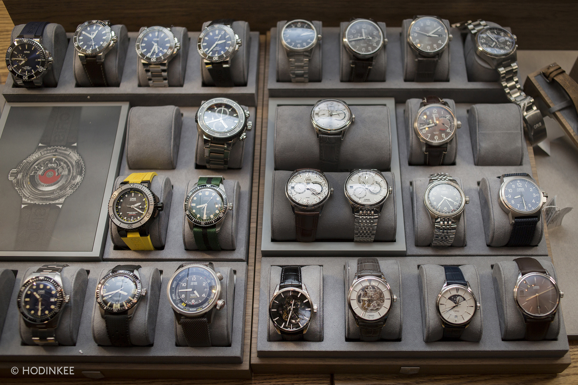 New York, polished walnut and glass watch display case with luxury timepieces